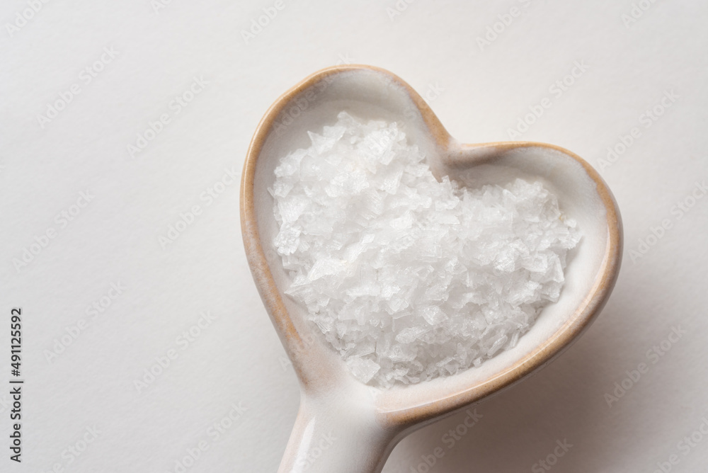 Sea Salt Flakes on a Heart Shaped Spoon Sea Salt Flakes on a Heart Shaped Spoon