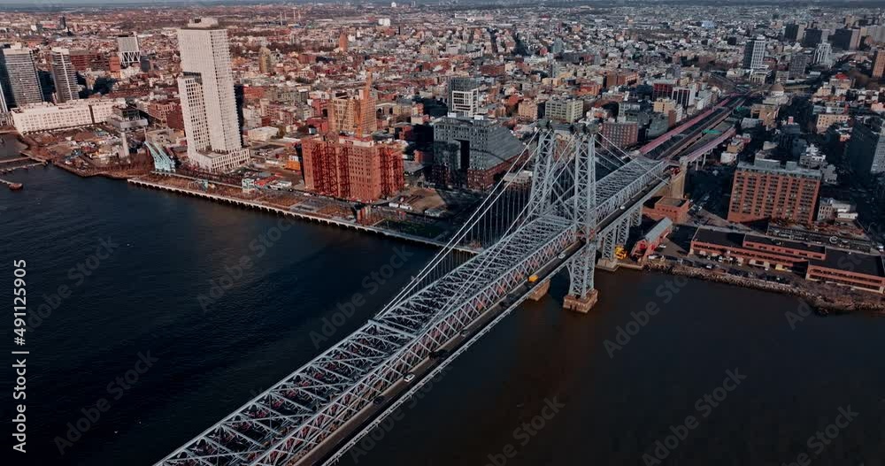 Williamsburg Bridge across East River with East Village and New York City skyscraper