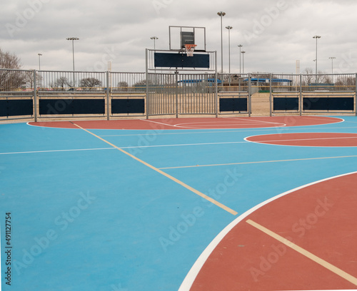 Outdoor basketball court surrounded by fence