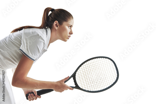 Playing tennis takes balls. Studio shot of a female tennis player holding a racket against a white background.