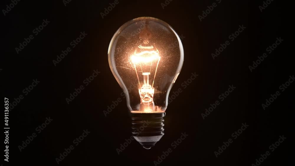 tungsten light bulb lighten on black background tungsten light bulb lighten on black background