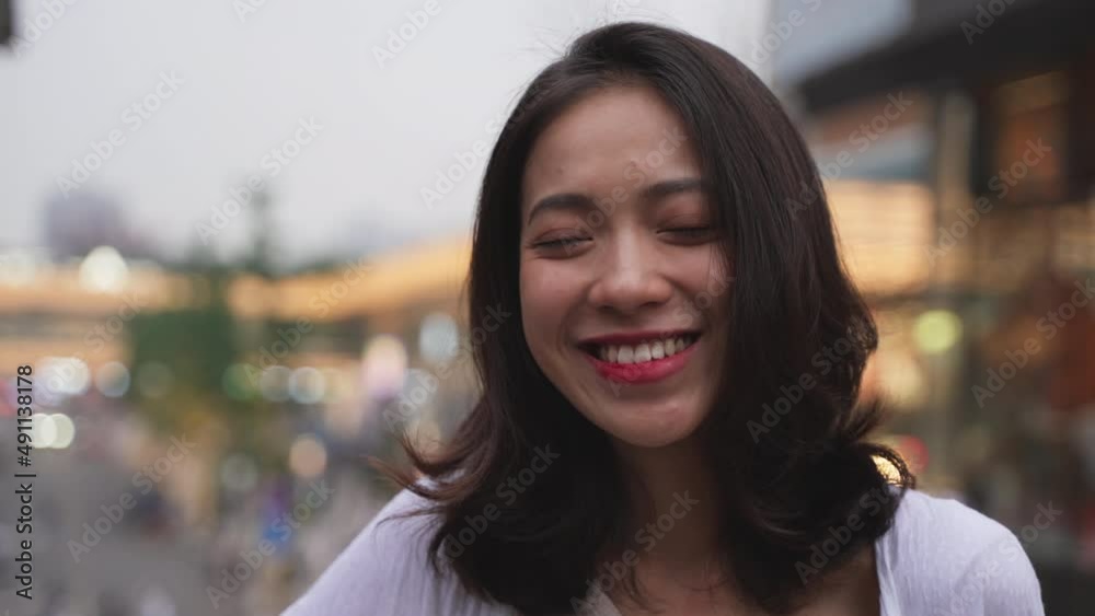 Lovely Chinese Young woman in white Looking at the Camera with Smile Happily in Twilight at Downtown in Chengdu Sichuan China Lovely Chinese Young woman in white Looking at the Camera with Smile Happily in Twilight at Downtown in Chengdu Sichuan China