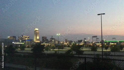 Omaha, Nebraska skyline lit up at night panned from left to right during summer season.