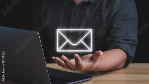 Email marketing concept.Businessman answering customer emails or digital newsletter to customers.