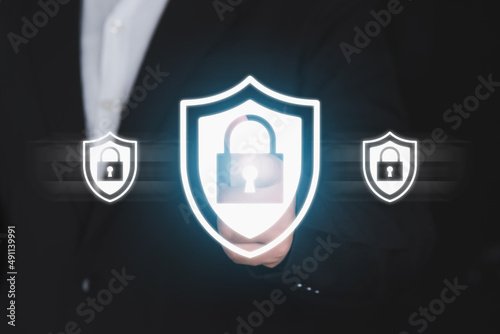 Businessman pressing security shield.Technology computer and internet cyber security and anti-virus concept.