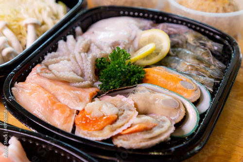 The seafood set includes shabu shabu in a plastic box. for takeout order put it on the dining table 