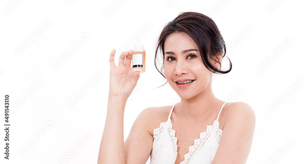 Asian young beautiful woman smiling she's holding bottle serum hair or skin care near face for present product isolated on over white background, Beauty salon concept Asian young beautiful woman smiling she's holding bottle serum hair or skin care near face for present product isolated on over white background, Beauty salon concept