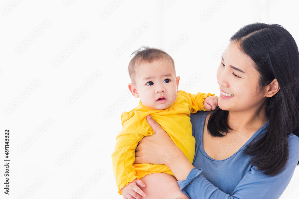 Portrait of beautiful young Asian mother holding his newborn little baby in her arms at home, Parent mom hugging her newborn child, happy family Portrait of beautiful young Asian mother holding his newborn little baby in her arms at home, Parent mom hugging her newborn child, happy family