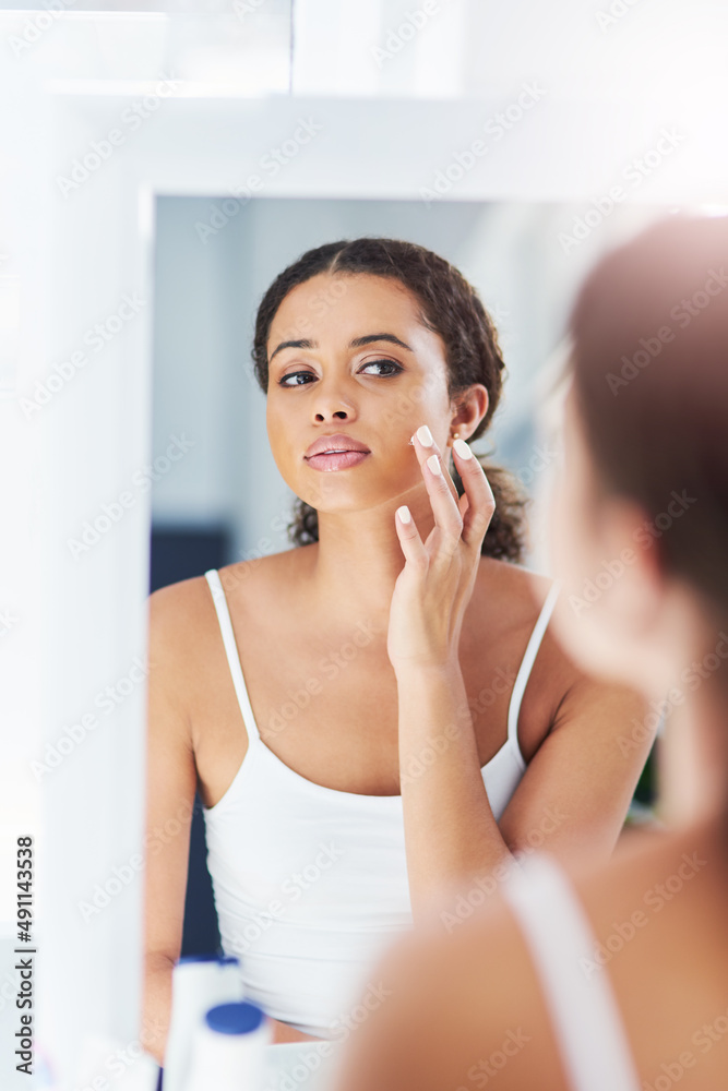 This product gives me instant results. Cropped shot of an attractive young woman applying moisturizer to her face. This product gives me instant results. Cropped shot of an attractive young woman applying moisturizer to her face.
