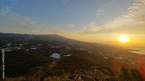 A hill in a rural village where you can see the sunset.