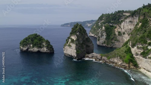 Aerial view of iconic Atuh beach surrounded by limestone cliff in Nusa Penida, Bali, Indonesia.