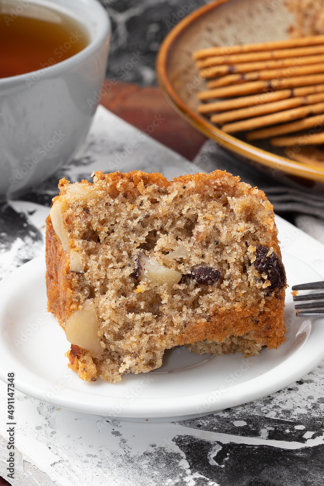 A piece of nuts cake on white plate. Selective focus. A piece of nuts cake on white plate. Selective focus.