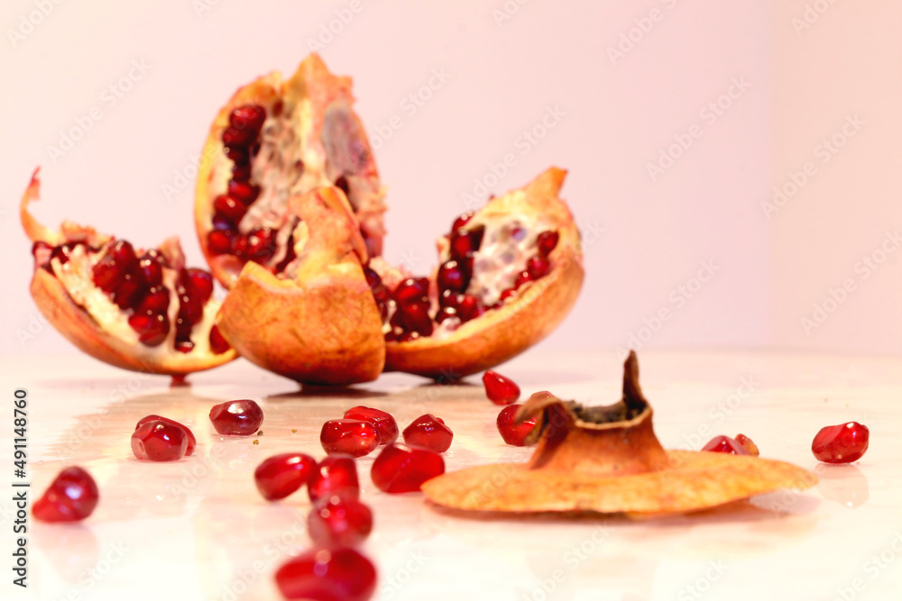 Pomegranate grains scattered on the table, blurred background Pomegranate grains scattered on the table, blurred background