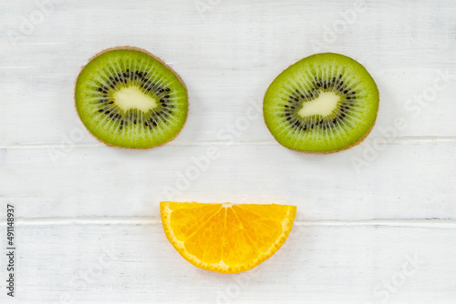 Funny pictures from slices of kiwi fruit and orange, children's food