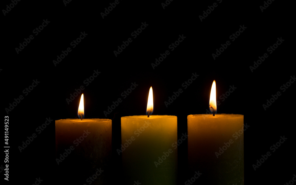 Warm candlelight on a dark mysterious background Warm candlelight on a dark mysterious background