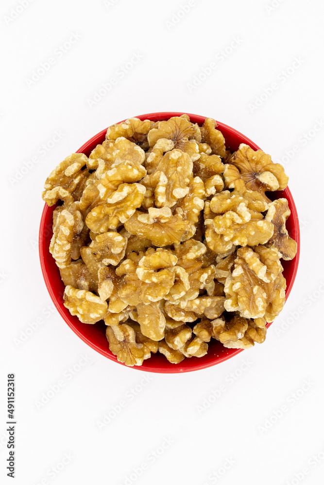 Peeled walnuts in red plate