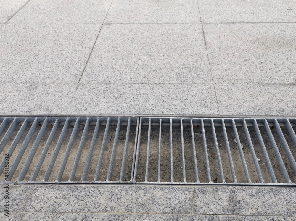 Fototapeta premium Drainage ditches on public pedestrian walkways.
