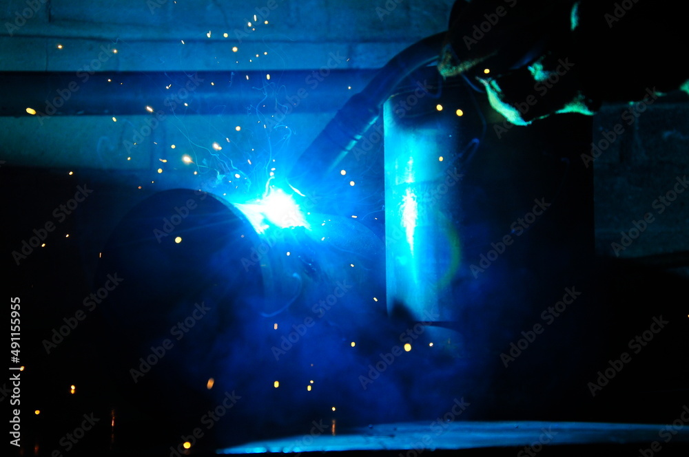 Welding of steel, sparking. Sparks from welding. Welding of pipes