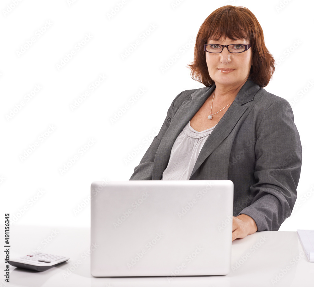 Im the boss around here. A business woman sitting at her desk with a calculator and laptop on her desk. Im the boss around here. A business woman sitting at her desk with a calculator and laptop on her desk.