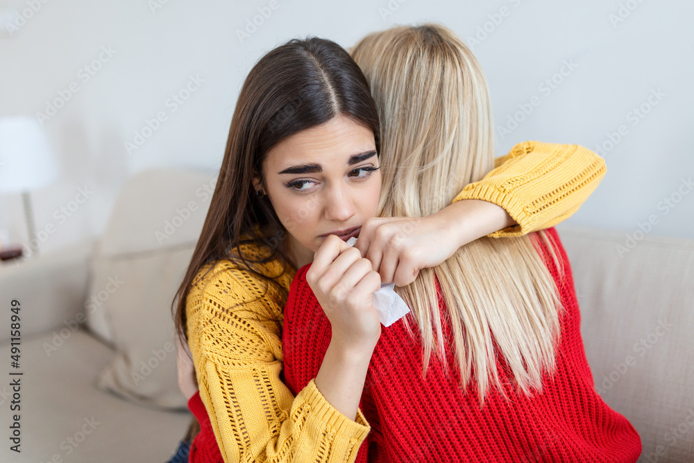 Woman hugging her depressed friend at home, closeup. Young woman supporting her crying girlfriend. Friendship consoling and care, copy space Woman hugging her depressed friend at home, closeup. Young woman supporting her crying girlfriend. Friendship consoling and care, copy space