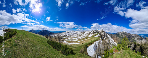 The summit cross of Rosenkogel (Rozca) with scenic view on mountain peaks in the Karawanks, Carinthia, Austria. Border with Slovenia. Triglav National Park. Alps in spring. Alpine meadows in spring photo