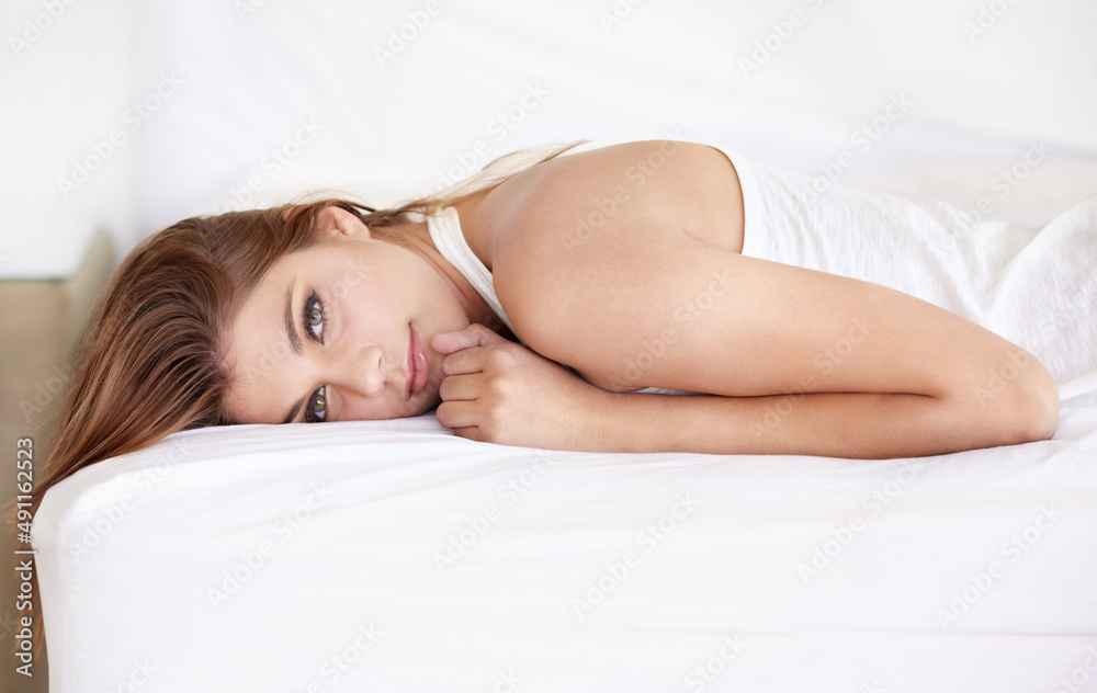 Being herself makes her beautiful. A gorgeous young woman lying on her bed in a sleepshirt. Being herself makes her beautiful. A gorgeous young woman lying on her bed in a sleepshirt.