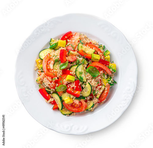 Vegetable salad with quinoa and fresh herbs is isolated on a white background.