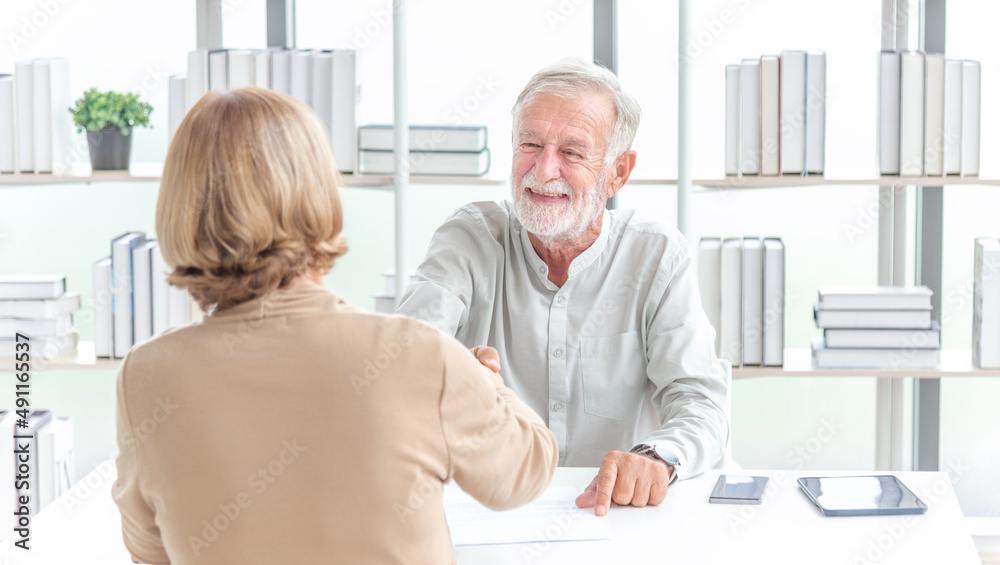 Happy middle aged bank manager sell loan insurance service shake customer hand. Happy older mature businesswoman shaking hand of male partner boss client greeting getting promoted rewarded
Happy middle aged bank manager sell loan insurance service shake customer hand. Happy older mature businesswoman shaking hand of male partner boss client greeting getting promoted rewarded