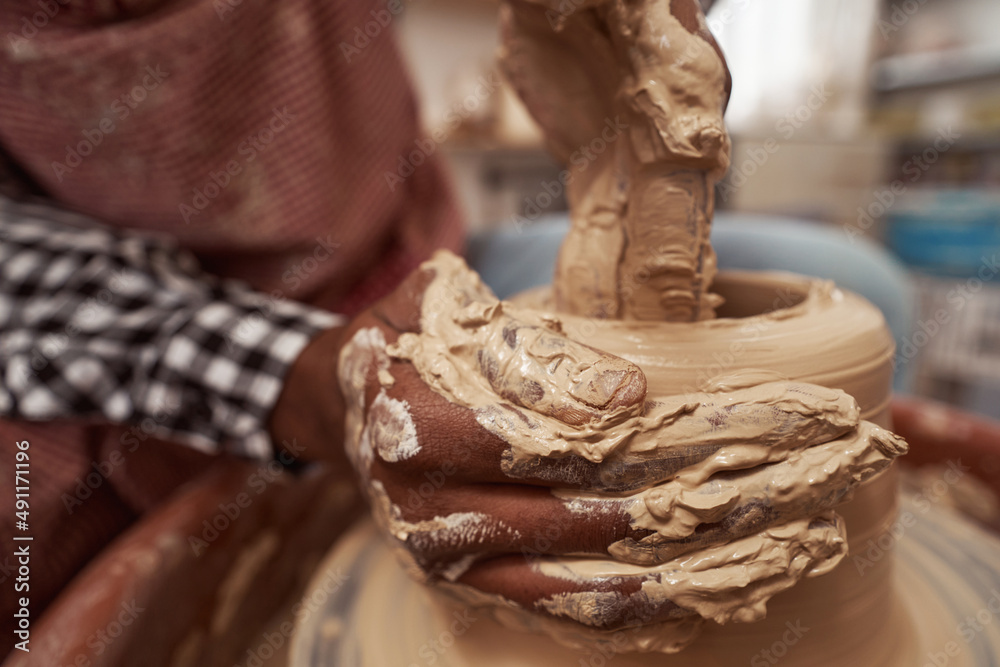 Professional male potter working on pottery wheel