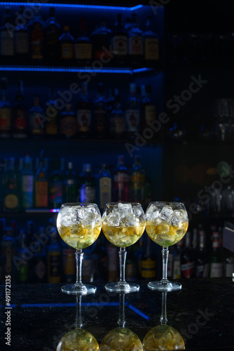 line of yellow refreshing cocktails on a bar desk