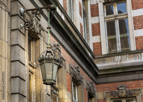 Antique lamp on the wall of Royal Conservatory of Brussels, Belgium photo