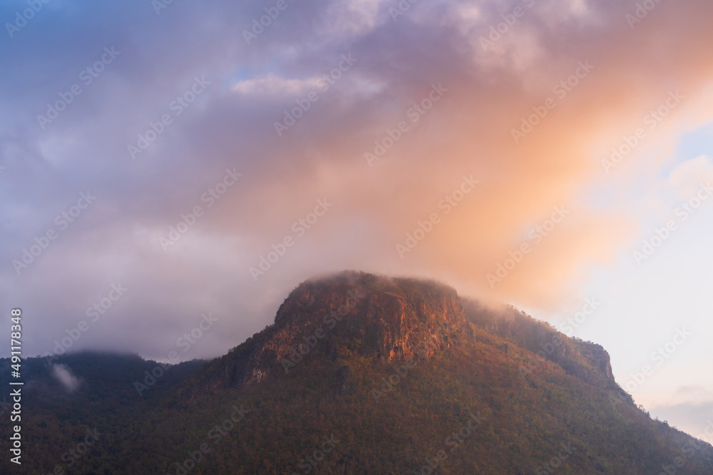 Landscape view of limestone mountain and forest with colorful sky at sunrise in beautiful rural valley of the Chiang Dao countryside, Chiang Mai, Thailand