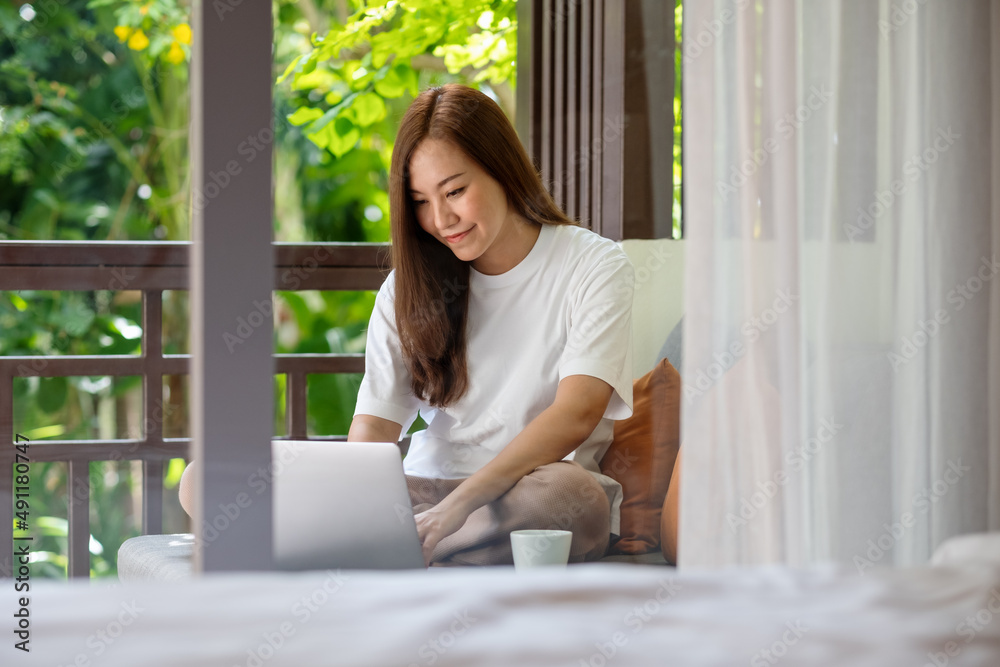 Portrait image of a young woman using laptop computer for working or studying online at home Portrait image of a young woman using laptop computer for working or studying online at home
