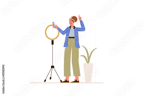 Live streaming concept in flat design. Young girl blogger broadcasting online to followers using ring light lamp and smartphone from home. Vector illustration with isolated people scene for web banner