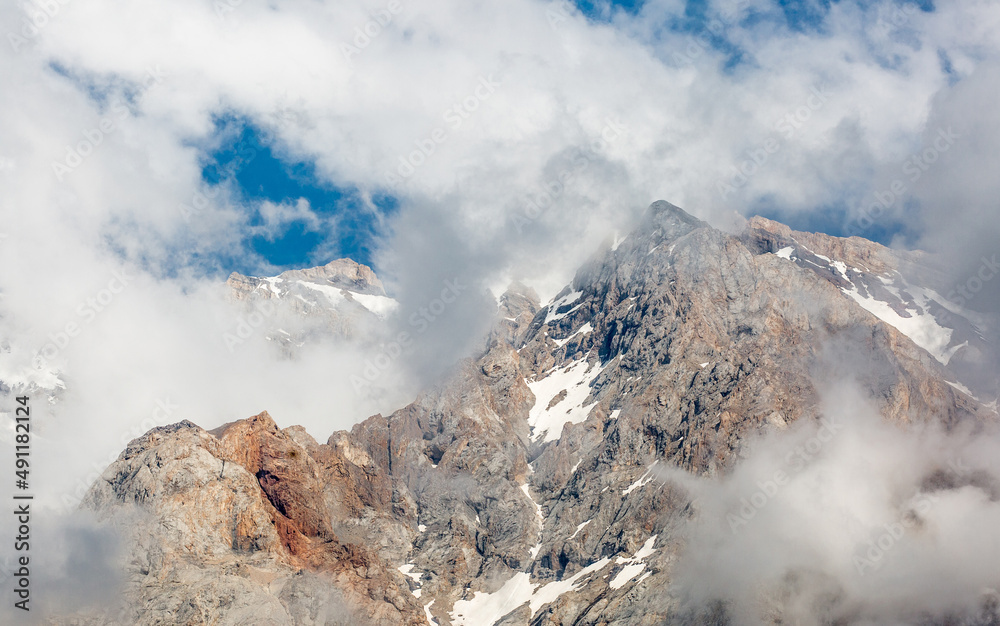 Beautiful nature of rocky mountains. Unusual landscape of nature. Trees among the rocks against the sky with clouds. Bad weather cyclone, rainy season, foggy day.