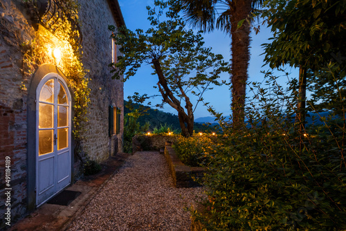 House or cottage at sunset with a beautiful garden in Tuscany. The place is romantic and makes you dream. photo