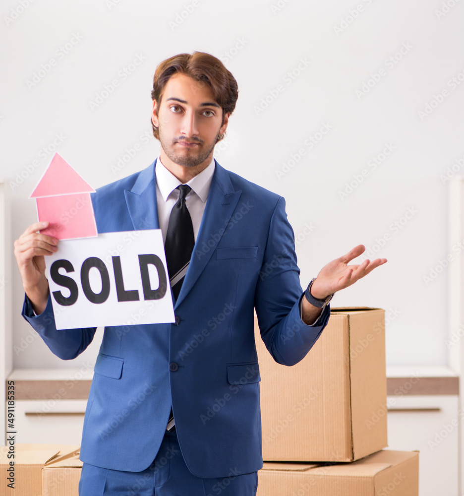 The young handsome realtor selling flat
