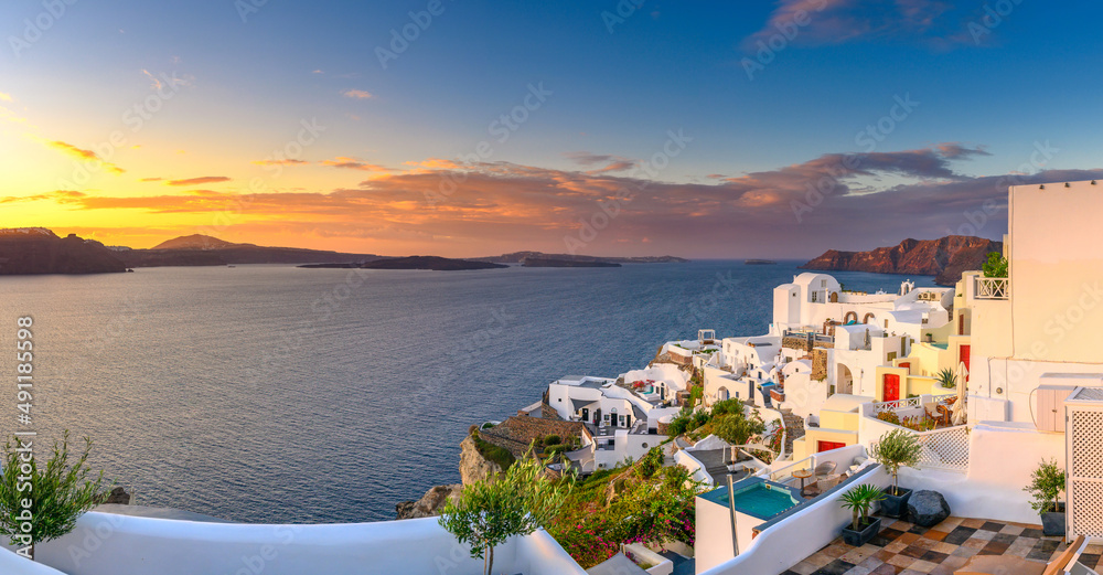 Picturesque sunset on famous view resort over Oia town on Santorini island, Greece, Europe. luxury travel. famous travel landscape. Summer holidays. Travel concept background.