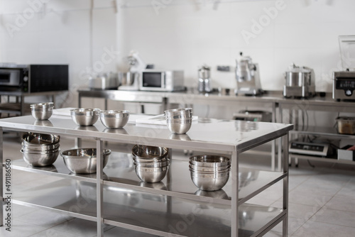 Professional restaurant kitchen with kitchen equipment and stainless steel tables. Interior with no people photo