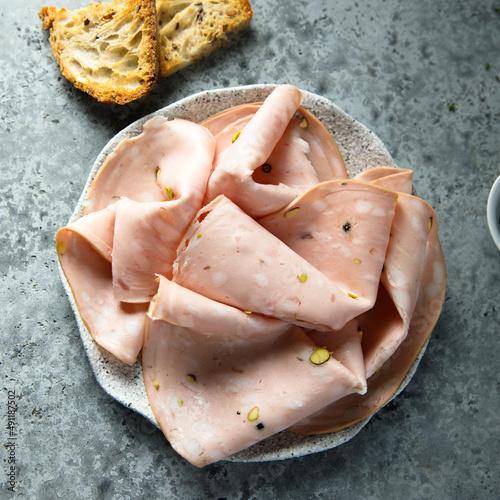 Slika na platnu Traditional Italian mortadella on a plate