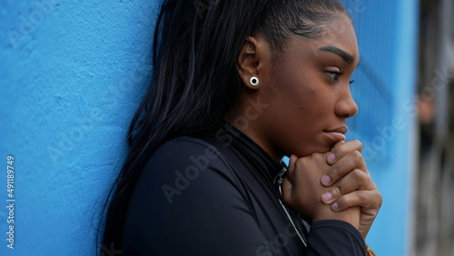 A pensive teen black girl in dilemma