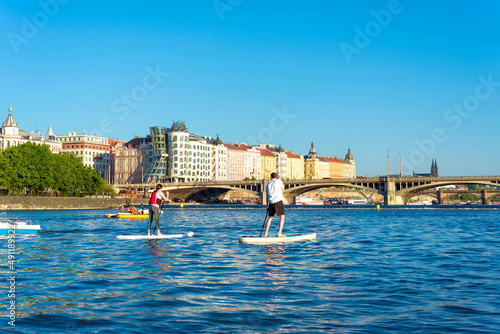 Canvas Print Stand-Up Paddling on Vltava river. Prague, Czech Republic