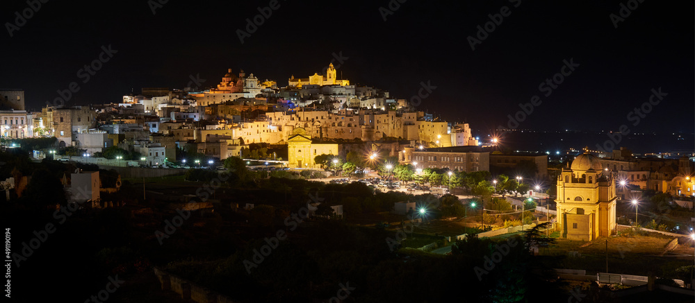 Panoramic wide view of Ostuni by night, the white city in Apulia, southern Italy