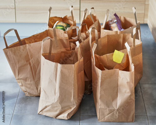 Eco friendly reusable shopping bags on a tiled floor