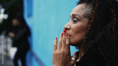 A desperate African woman outside in street feeling anxious