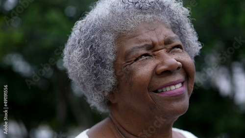 A contemplative black senior woman closing eyes in meditation