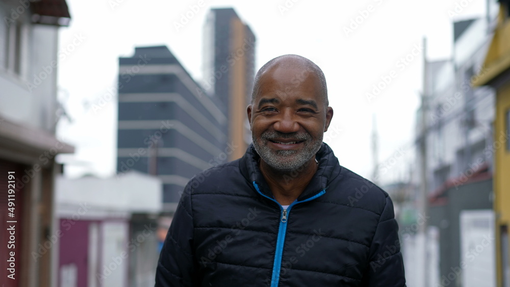 A Brazilian black person walking forward outside in urban street A Brazilian black person walking forward outside in urban street