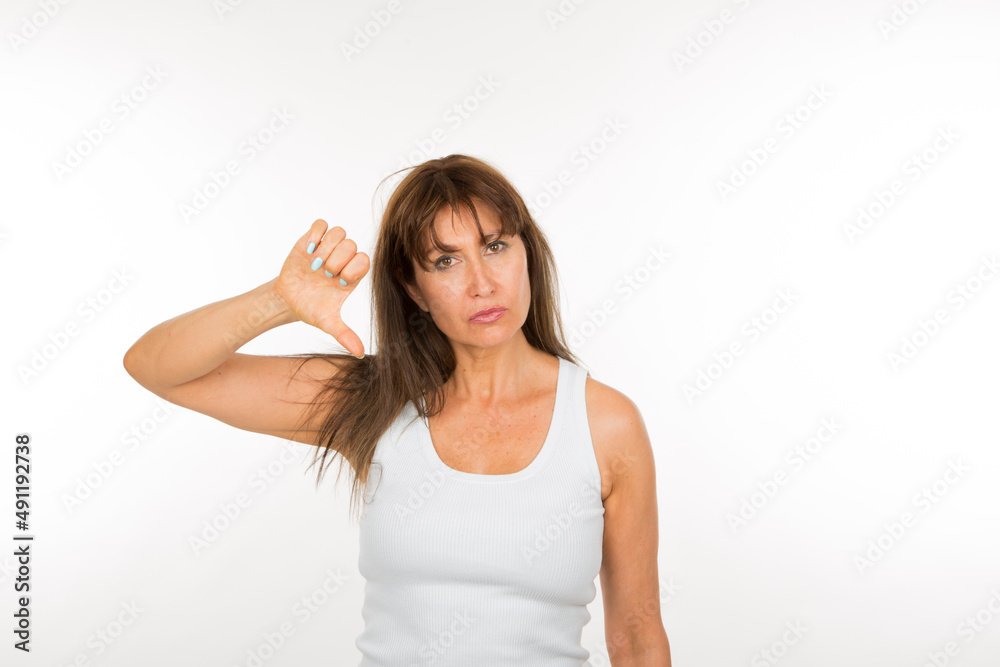 portrait senior woman with thumb down being negative smiling on white background portrait senior woman with thumb down being negative smiling on white background