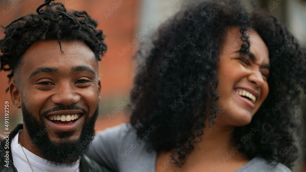 A black couple embrace an african man and woman hug posing