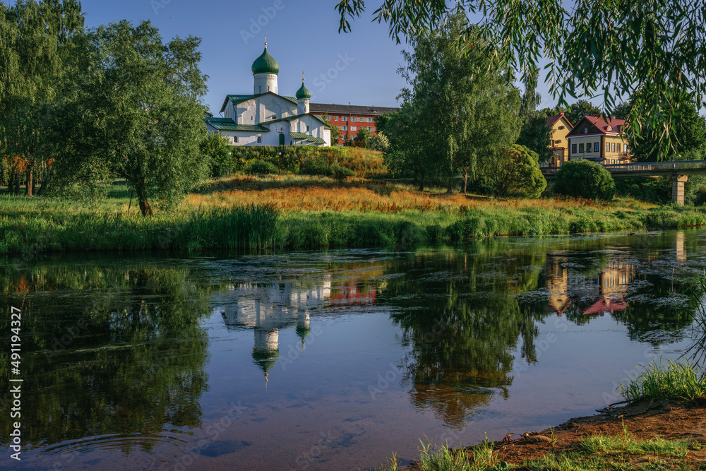 View of the Church of Epiphany s Zapskovya on the bank of the Pskova River on a sunny summer day, Pskov, Russia
